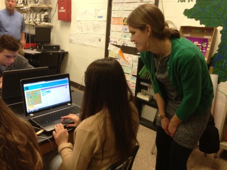 Science teacher Heather Baron watches a student use an Hour of Code tutorial.